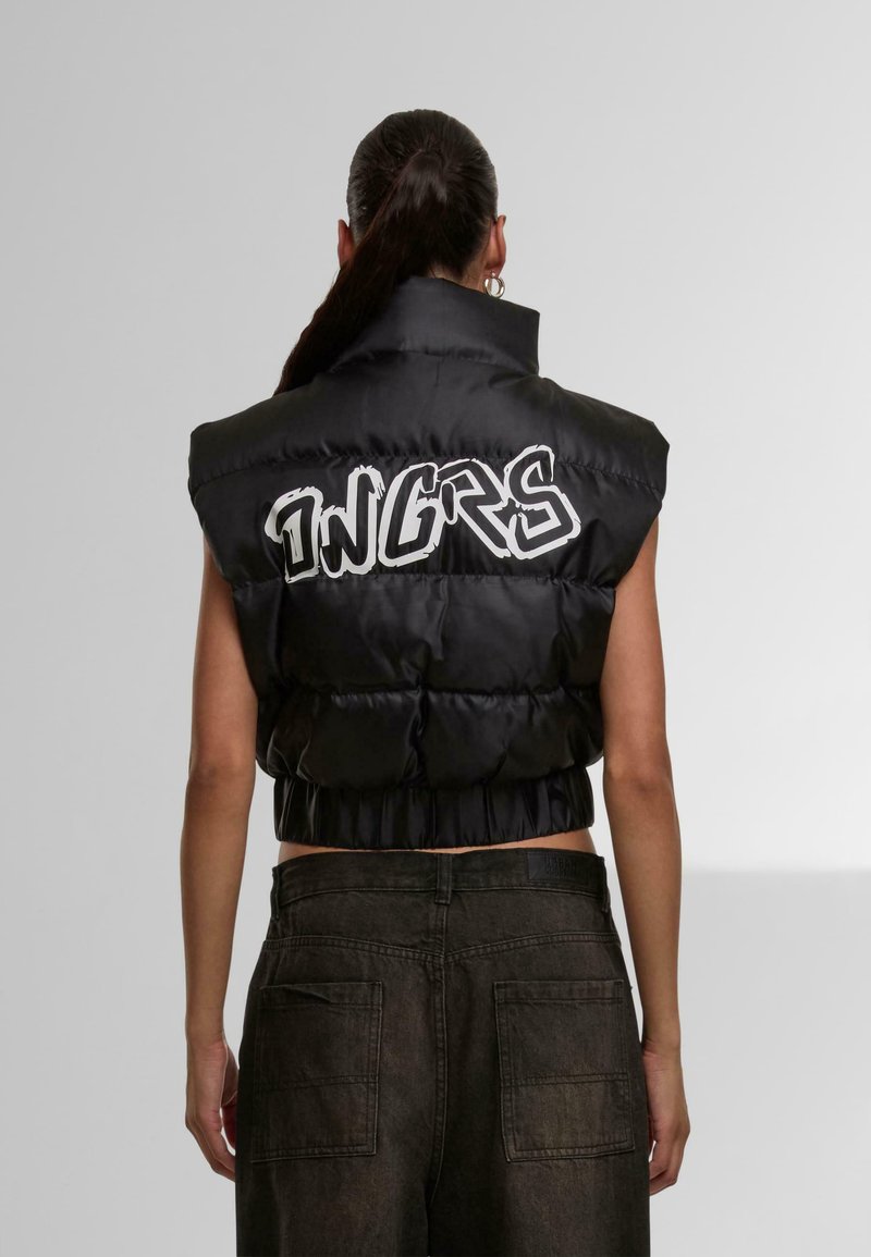 Black padded vest with a high collar and cropped design. Features large white "INGRS" lettering on the back, smooth texture, and shiny finish.