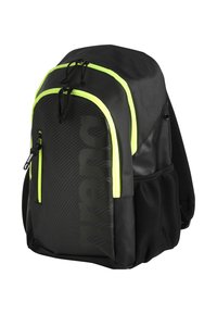 Zaino nero con zip verde lime, tasca laterale in rete e grande motivo del logo. Presenta spallacci imbottiti e materiale resistente.