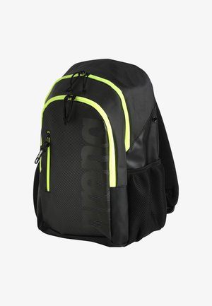 Zaino nero con zip verde lime, tasca laterale in rete e grande motivo del logo. Presenta spallacci imbottiti e materiale resistente.