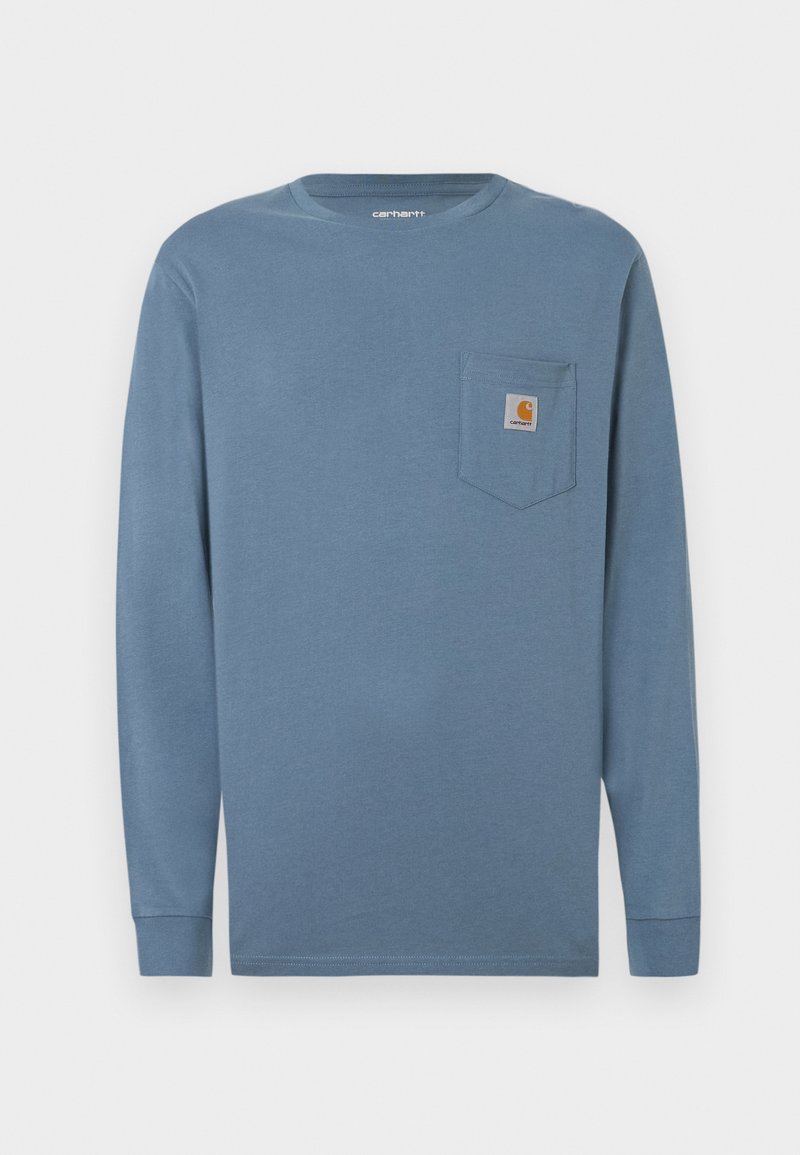 Langærmet blå skjorte i bomuld med rund halsudskæring, brystlomme til venstre og Carhartt-logo. Blød tekstur, lige kant og tætsiddende ærmer.