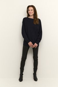 Navy long-sleeve knit sweater with a relaxed fit, paired with black fitted leather pants and black ankle boots. Simple and sleek design.