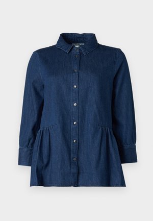 Dark blue denim shirt with a collared neckline, button closure, and gathered waist. Features long sleeves and two side pockets.