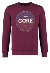 Sudadera granate con cuello redondo, puños acanalados y un gráfico circular que presenta la palabra "CORE" en líneas blancas y azules.