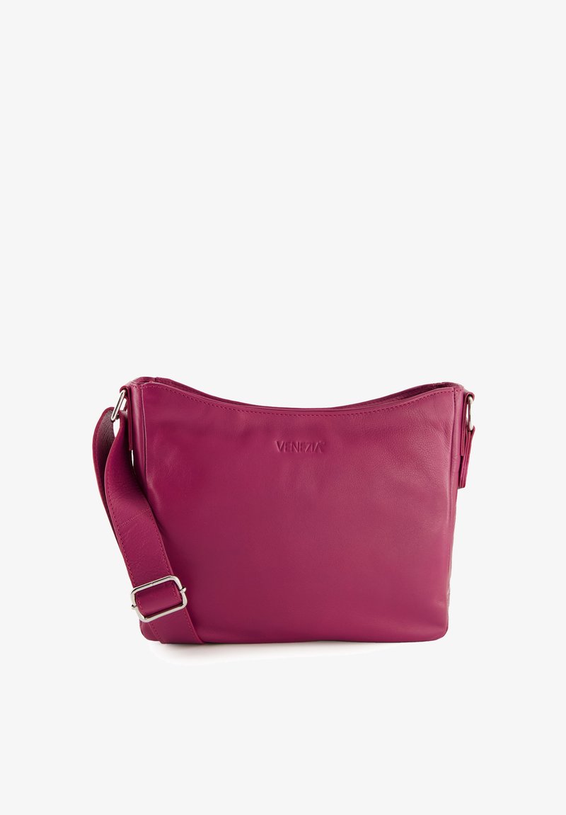 Pink leather crossbody bag with a curved top, adjustable strap, and embossed logo detail on the front. Smooth texture and clean design.