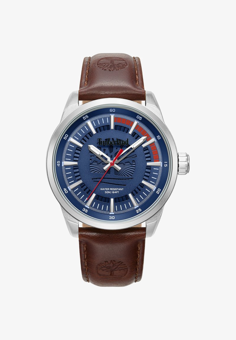 Zegarek z brązowym skórzanym paskiem, stalową kopertą, granatową tarczą, białymi znacznikami godzin oraz czerwoną wskazówką minutową. Wodoodporny.