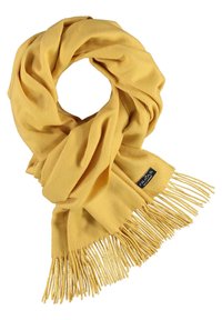 Écharpe jaune en tissu doux, avec un design en boucle et des bords frangés. Une petite étiquette de marque est visible d'un côté.
