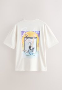 Cream-colored T-shirt featuring a graphic design with a guitar and amplifier, colorful accents, and a playful retro illustration.