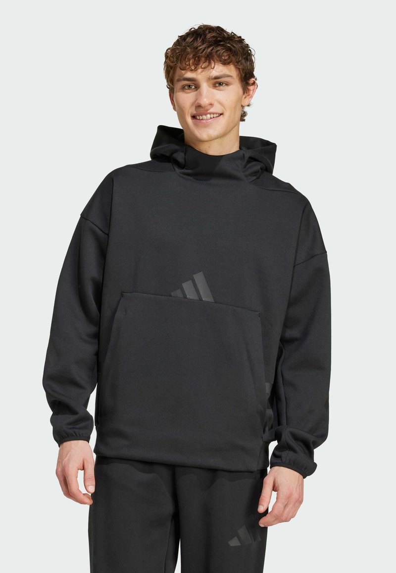 Black hooded sweatshirt with a front pocket, made from soft material, featuring a relaxed fit and subtle logo detail on the pocket.