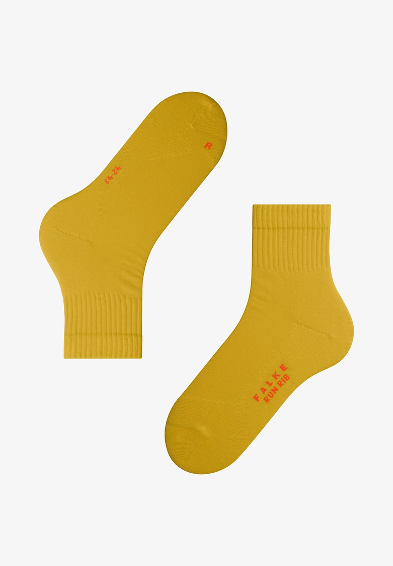 Gelbe Baumwollsocken mit gerippten Bündchen und roter Markenkennzeichnung. Sie verfügen über eine abgerundete Zehenpartie und eine taillierte Form für Komfort, gekennzeichnet mit 'R' für den rechten Socken.