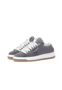 Gray suede sneakers with white laces, a rubber sole, and perforated detailing. Features a logo on the side and a cushioned collar.