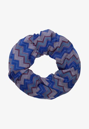 Chouchou en tissu bleu et violet avec des motifs en zigzag et à rayures rouges et blanches, présenté sur un fond blanc.