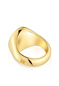 Gold-toned ring featuring a smooth, curved design with a twisted shape. Engraved with "TOUS S925" on the inner band for authenticity.