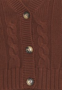 Hnědý pletený kardigan s kabelovými vzory, žebrovanými manžetami a dvěma velkými kulatými krémovými knoflíky. Texturovaná tkanina, která ukazuje teplý a útulný design.