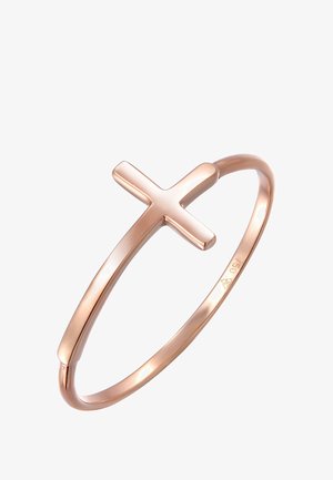 Bracelet en or rose avec une finition lisse et brillante ainsi qu'un design de croix prominent. Forme circulaire, style minimaliste, sans embellissements supplémentaires.