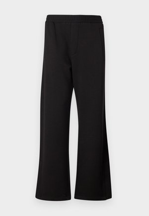 Black flared sweatpants with an elastic waistband and two side pockets. Made from soft, smooth fabric with no visible patterns or graphics.