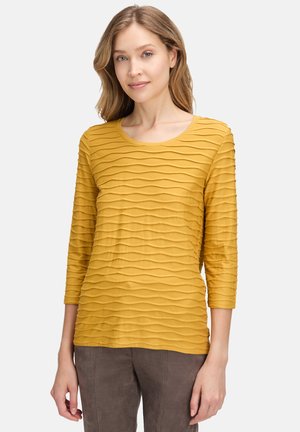 MIT WELLENSTRUKTUR - Bluse - gold