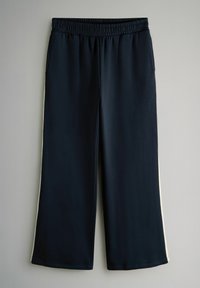 Navy blue wide-leg sweatpants with elastic waistband and white side stripes, hanging against a plain light background.
