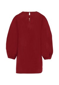 Tunique rouge avec de longues manches bouffantes et un détail en forme de trou de serrure dans le dos. Fabriquée dans un tissu lisse avec une couleur unie et une coupe décontractée.