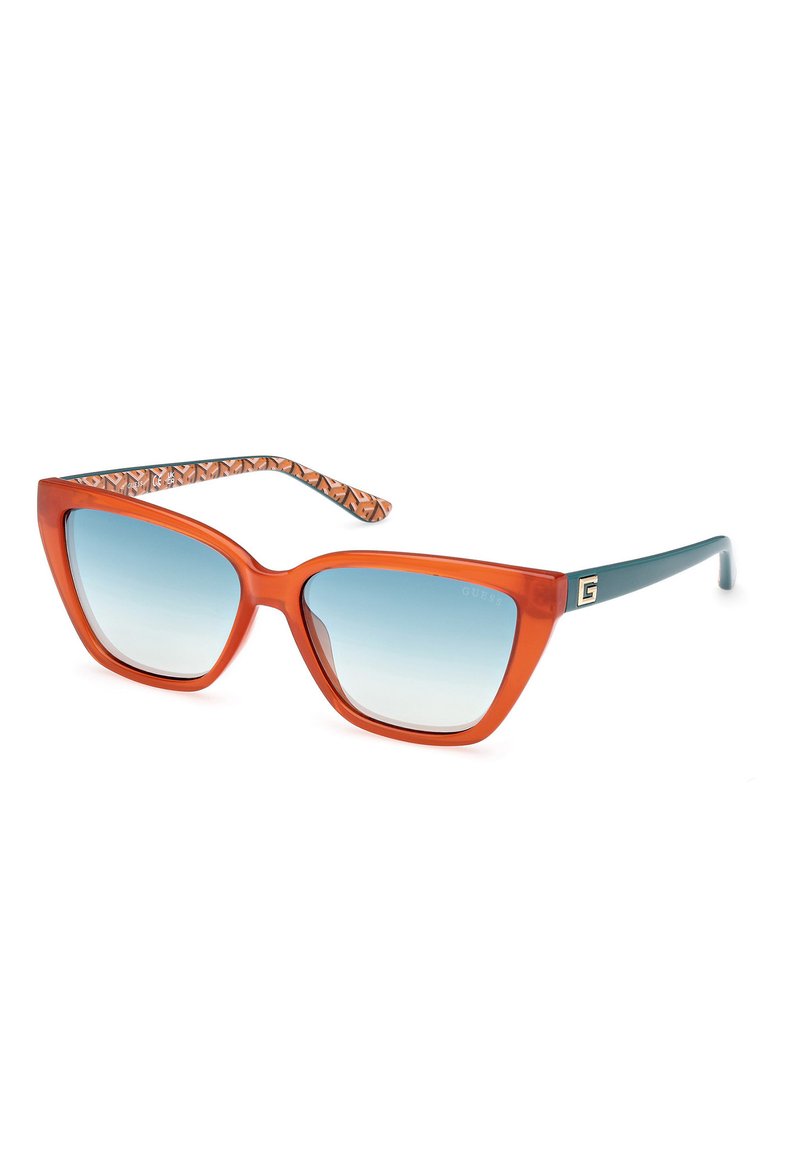 Occhiali da sole oversize arancioni con un design geometrico, lenti blu sfumate e dettagli delle stanghette a motivo in tonalità di marrone e arancione.