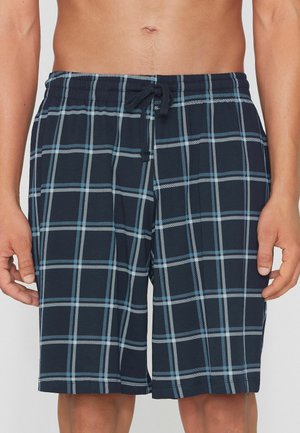 Männlicher Oberkörper und obere Beine, bekleidet mit marineblauen karierten Shorts mit hellblauen und weißen Linien, elastischem Bund und vorderer Kordel zum Binden.