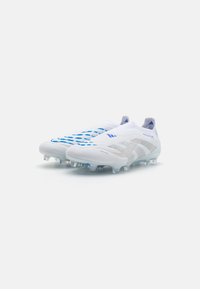 White football boots with blue accents, textured upper, sock-like design, transparent cleats, and distinctive pattern on the surface.
