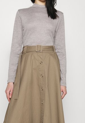 Grey, ribbed long-sleeve top paired with a tan, knee-length skirt featuring a button front and a matching belt at the waist.