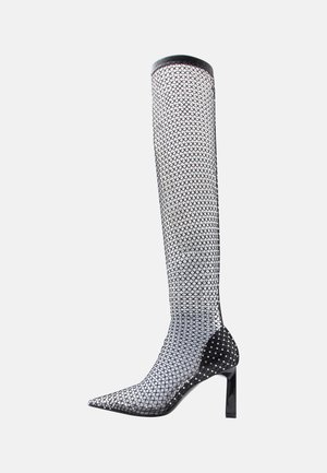 Schwarzer knielanger Netzstiefel mit spitzer Zehe, verziert mit glänzenden Akzenten und einem glänzenden schwarzen Absatz. Verfügt über ein elegantes, strukturiertes Design.