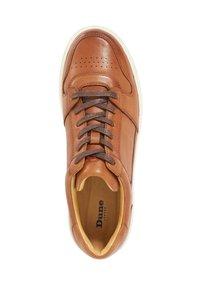 Brown leather sneaker with perforated detailing, flat brown laces, and a white rubber sole. Interior lining in light brown. Brand name visible.