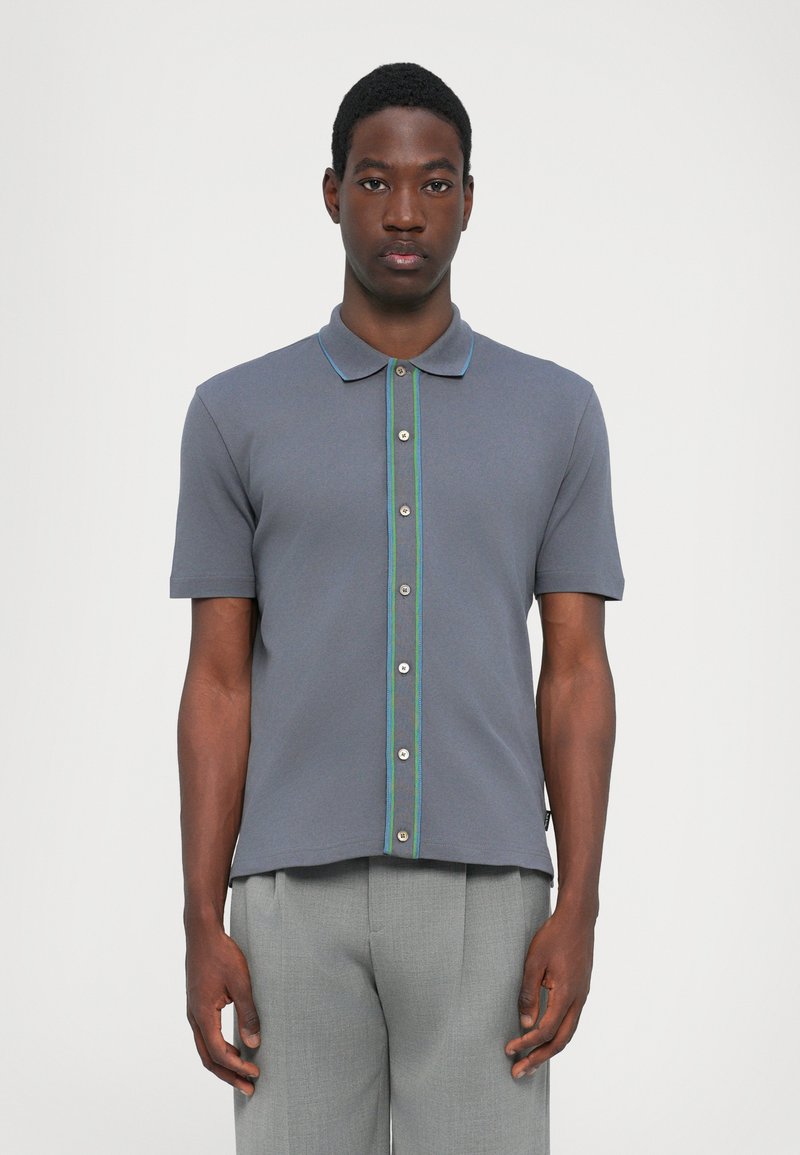 Short-sleeve polo shirt in gray, featuring a buttoned front with green and blue accents, made from a smooth, textured fabric.