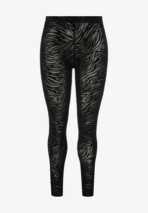 Leggings noirs avec une finition brillante, présentant un motif de rayures zébrées texturées dans des nuances variées de noir et de gris.