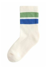 Knee-high sok in ivoor met ribbeltextuur en drie horizontale strepen in groen, blauw en donkerblauw aan de bovenkant.