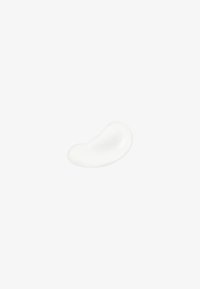 Vit kräm eller lotionklump, slät textur, böjd form som påminner om ett bönor, på en enfärgad bakgrund.