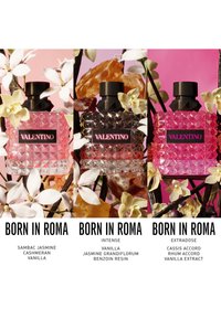 Three Valentino Born in Roma perfume bottles with floral and natural elements background, labeled with different scent notes below each bottle.
