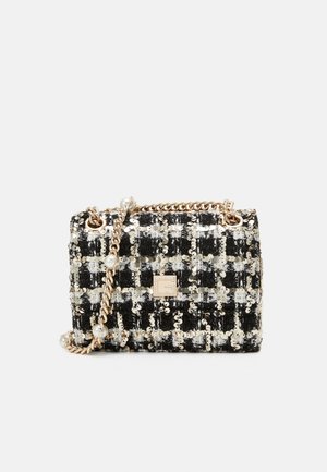 Sac à main noir et blanc à sequins avec bandoulière chaîne dorée et accents en perles, avec une petite plaque logo dorée sur le devant.