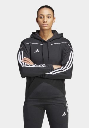 Schwarzer Hoodie mit weißen Akzenten und dreistreifigem Design an den Ärmeln. Weiches Material mit einer Fronttasche und verstellbarem Kordelzug an der Kapuze.