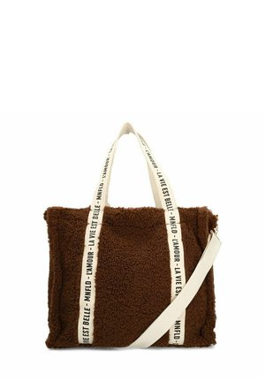 Brown faux fur tote bag with cream straps featuring printed text. Soft texture, rectangular shape, and adjustable shoulder strap.