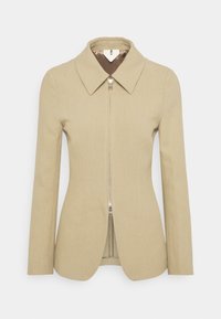 Veste beige ajustée avec un grand col, une fermeture éclair à l'avant et des manches longues. Fabriquée en tissu texturé, avec une doublure intérieure contrastante.