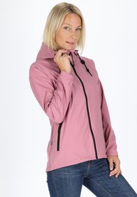 Light pink jacket with a hood, black zipper detailing, and adjustable drawstrings. Features a smooth texture and slim fit design.
