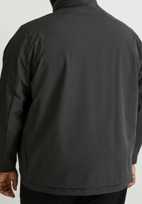 Giacca impermeabile grigio scuro, progettata con colletto alla coreana, maniche lunghe e una texture liscia. Stile minimalista, senza motivi o accenti visibili.