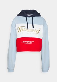 Kapat sweatshirt med ljusblå, vit och röd panel, med en marinblå huva och guld "Tommy Jeans"-logotyp. Material av bomullsblandning.