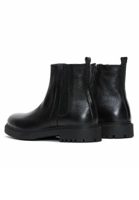 Bottines en cuir noir avec une finition texturée, des panneaux latéraux élastiques et une semelle en caoutchouc robuste, dotées d'une fermeture éclair à l'arrière pour un enfilage facile.