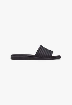 Chausson noir avec une tige à rayures, semelle plate et texture lisse. Fabriqué à partir d'un matériau flexible pour plus de confort.