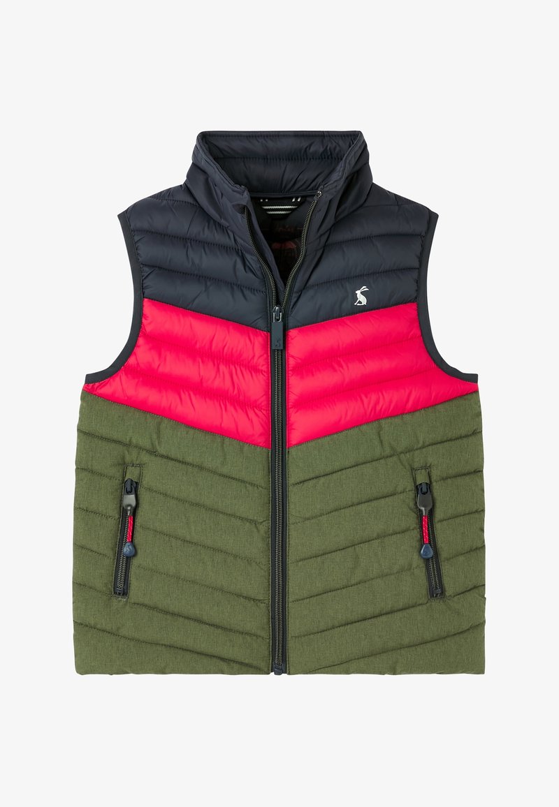 Veste matelassée sans manches avec partie supérieure noire, milieu rouge et bas vert olive, fermeture éclair à l'avant et deux poches zippées.