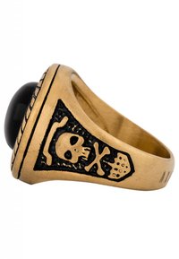 Anello in tonalità oro con una pietra nera. Il design include un motivo di teschio e ossa incrociate con dettagliate incisioni.
