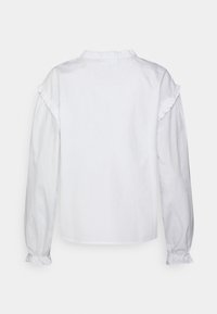Camisa branca de mangas longas com colarinho e punhos franzidos, apresentando um corte descontraído e uma textura de algodão suave. A vista posterior mostra um design simples.