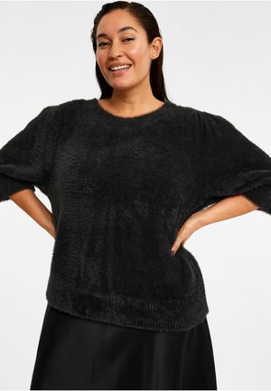 Zwarte, fuzzy pullover trui met een ronde halslijn, korte mouwen en een losse pasvorm. Zachte textuur met een iets verkorte zoom.