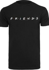 Svart bomullst-shirt med ordet "FRIENDS" i vitt, med färgglada prickar mellan bokstäverna. Korta ärmar och rundad halsringning.