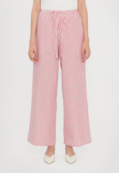 Pantalons larges rayés rouges et blancs avec une taille élastique et un détail de lien, en tissu léger et avec une coupe ample.