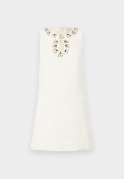 White dress with a textured fabric, featuring a floral bead-embroidered neckline and a keyhole detail at the front.