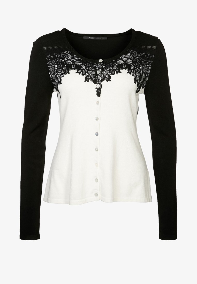 Svart och vit långärmad cardigan med spetsdetaljer vid halsringningen, knappstängning och strukturerad tyg.